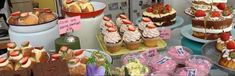 many different types of cakes and pastries on display