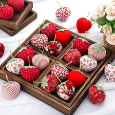 some strawberries are sitting in a wooden box