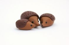 two toy hedgehogs sitting next to each other