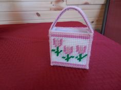 a pink and white bag sitting on top of a red table