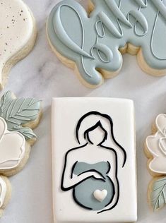 decorated cookies and cookie cutters on a table