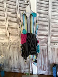 a dress on display in front of wooden shutters