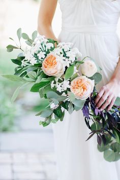 a woman holding a bouquet of flowers in her hands