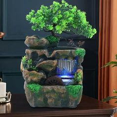 a bonsai tree is displayed on top of a table with water flowing from it