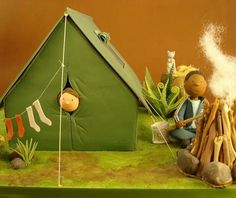 a cake that is decorated to look like a camper and his tent with socks on it