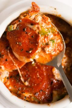 a white bowl filled with meat covered in marinara sauce