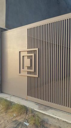 an open door on the side of a building that has vertical lines and rectangles carved into it