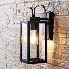 an outdoor light on the side of a brick wall