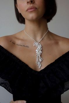 Inspired by swans, this statement piece features genuine freshwater pearls fashioned in  a way that mimics feathers.  There is no clasp, gently slide the pearl loop off to put on.  You can also adjust where it sits.  Closure: no clasp Materials: 14K Gold Filled or Sterling Silver Measures approx. 20" in length Handmade Elegant Feather Dangle Jewelry, Elegant Sterling Silver Feather Jewelry, Affordable Fine Jewelry, Shoulder Duster Earrings, Dainty Pearl Necklace, Designer Necklace, Wrap Necklaces, Jewelry Pearl, Layered Jewelry