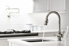 a kitchen sink with a faucet and soap dispenser