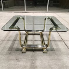 a glass table sitting on top of a sidewalk