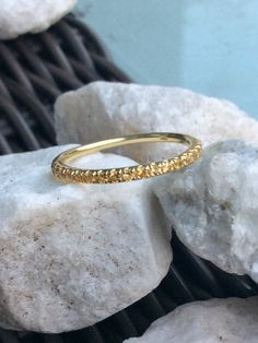 a close up of a gold ring on some rocks