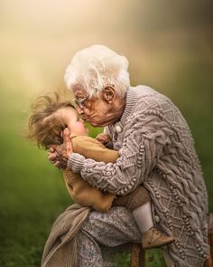 an old woman holding a small child in her arms