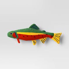 a green and yellow fish hanging on the wall