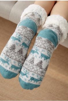 Walking in the Winter Wonderland or even just on your cold floors in the winter; these knitted slipper socks will keep your feet nice and cozy on those cold winter days and nights. Featuring a with faux fur lining and a rubber sole design on the bottom to prevent slipping when walking these are sure to be a new favorite part of your lounge wear. Made with a polyester and cotton blend. Comes in 21 fun patterns from which to choose. Slipper Design, Halloween Wigs, Soft Sock, Halloween Sweater, Winter Socks, Black Heel Boots, Cotton Clothing, Thick Socks, Knitted Slippers