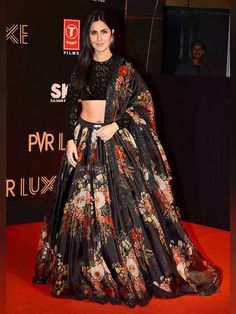 You are about to make the most beautiful party look by wearing this Sabyasachi designer lehenga choli.  This black lehenga in organza material embellished with floral print all over. Comes with black color choli decoded with full sequins work all over and black dupatta with similar floral print all over.  This lehenga choli is semi-stitched, can be customized up to 44 sizes.The black lehenga comes with can-can in the side.   This party wear lehenga choli is showcased by Katrina Kaif.        Pric Black Lehenga Choli, Black Lehenga, Sabyasachi Lehenga, Indian Outfits Lehenga, Floral Lehenga, Organza Lehenga, Indian Salwar Kameez, Lehenga Choli Online, Party Wear Lehenga