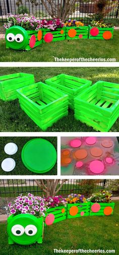 some green and pink painted wooden crates in the grass with flowers growing out of them