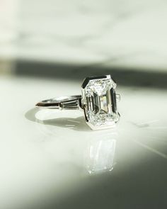 a diamond ring sitting on top of a table