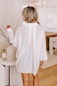 - This breezy button up is perfect for chic seaside style! - Unlined sheer material with a striped pattern A collared v-cut neckline - Long, loose sleeves with button closure cuffs - A functional chest pocket - A button up front - A pleated accent at the back - A relaxed silhouette that ends in a high-low hemline with a rounded back White Top With Striped Collar For Beach, White Top With Striped Collar For The Beach, White Button-up Blouse With Striped Collar, White Summer Blouse With Striped Collar, White Striped Collar Button-up Blouse, White Blouse With Striped Collar For Summer, Day Out Blouse With Striped Collar, Spring White Blouse With Striped Collar, White Blouse With Striped Collar For Spring