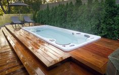 a hot tub sitting on top of a wooden deck