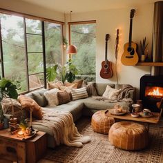 a living room filled with furniture and a fire place in front of a large window