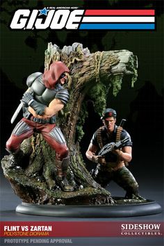 two figurines are posed in front of a tree