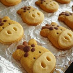 some cookies are shaped like pigs on tin foil