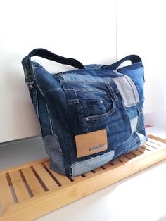 a denim bag sitting on top of a wooden shelf