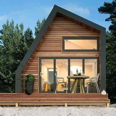 a small wooden house sitting on top of a sandy beach