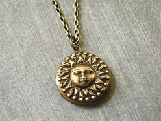 Small Sun Hidden Locket Necklace... This celestial sun locket has an antique brass finish and is attached to an antique brass round locket. The chain is a non tarnish soldered antique brass rolo chain made of brass. This chain closes with a lobster claw clasp. A great gift for women and men! Locket - 20mm Interior photo area - 14mm This beautiful celestial locket will be mailed to you gift wrapped. A great gift for someone you love! More celestial lockets listed in this section! https://www.etsy Antique Finish Adjustable Round Jewelry, Bronze Bohemian Locket Necklace, Bohemian Brass Locket Necklace With Vintage Charm, Vintage Locket Jewelry For Festivals, Bohemian Antique Gold Brass Locket Necklace, Vintage Festival Locket Jewelry, Adjustable Brass Jewelry With Sun Design, Adjustable Brass Sun Design Jewelry, Bronze Brass Locket Necklace With Antique Finish