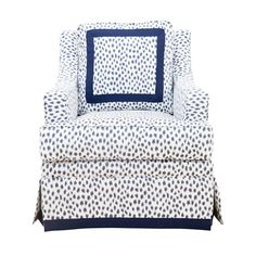 a blue and white chair with polka dot print on the back, in front of a white background