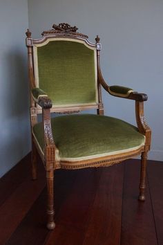 a green chair sitting on top of a wooden floor