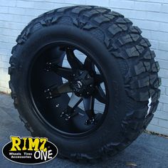 a large black wheel and tire on a truck