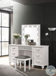 a white vanity with stool and mirror in a room