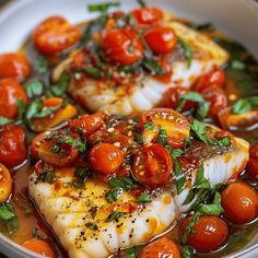 some fish and tomatoes are in a bowl