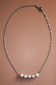 This dainty silver necklace is all one length. Its chain is simple but ends with white pearls. Length: 8 1/2” Dainty Metal Chain Necklace For Formal Occasions, Silver Long Delicate Chain Necklace, Minimalist Single Strand Chain Necklace For Formal Occasions, Dainty Silver Pearl Necklace With Adjustable Chain, Delicate Silver Snake Chain Necklace, Classic Silver Chain Necklace With Pearls, Silver Pearl Necklace With Delicate Chain For Formal Occasions, Dainty Silver Link Necklace, Formal Silver Pearl Necklace With Delicate Chain