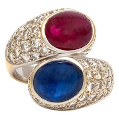 Ring finely crafted in 18K white gold with Cabochon Ruby and Sapphire surrounded with diamonds. The Cabochon Sapphire weighing approximately 4.00 carat. The Cabochon Ruby weighing approximately 4.00 carat. The diamonds weighing approximately 3.20 carat. The ring size is 6.5 US and 53 EU. Ruby And Sapphire, Cabochon Ruby, Yellow Gold Cocktail Ring, Gold Cocktail Ring, Blue Sapphire Diamond, Sapphire Diamond Ring, Pear Shaped Diamond, Art Deco Ring, Baguette Diamond