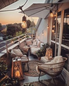 an outdoor patio with wicker furniture and hanging lights