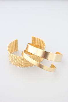 18k gold plated brass cuff. 1/4 inch wide. Gold Open Cuff Elegant Jewelry, Elegant Gold Open Cuff Jewelry, Modern Gold-tone Gold Plated Cuff Bracelet, Modern Gold Open Cuff Jewelry, Yellow Gold Polished Cuff Bracelet, Gold Open Cuff Bracelet For Formal Occasions, Adjustable Gold-plated Bangle With Polished Finish, Gold Metal Jewelry With Thick Band, Modern Gold Cuff Jewelry