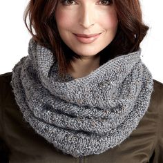 a woman wearing a gray knitted scarf