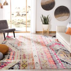 a living room filled with lots of furniture and rugs on top of a wooden floor