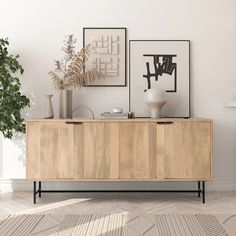 a wooden cabinet sitting in the middle of a living room next to a potted plant