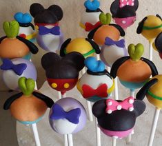 there are many mickey mouse cake pops on the stick