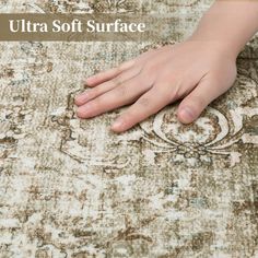 a person's hand on an area rug with the words ultra soft surface