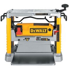 the dewt band sawing machine is yellow and gray with black accents on it