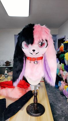 a pink and black bunny costume sitting on top of a table