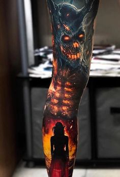 a person with a tattoo on their leg that has an image of a demonic demon