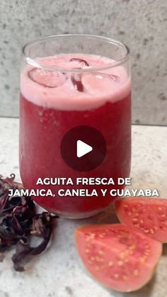 a glass filled with liquid next to sliced watermelon