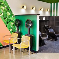 the interior of a hair salon with chairs and mirrors