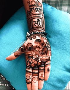 a woman's hand with henna tattoos on it